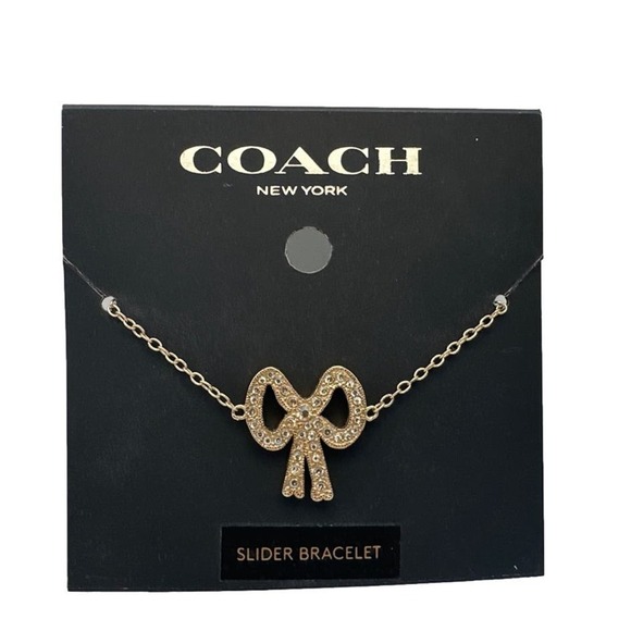 NWT Coach Pave Crystal Gold Tone Ribbon Charm Slider Bracelet - Picture 1 of 3